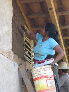 A resident building her home