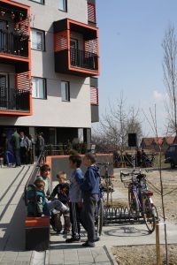 Children play outside SHSE apartments in Negotin